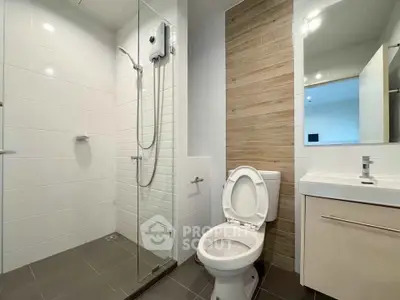 Modern bathroom with sleek shower and contemporary fixtures in a stylish apartment.