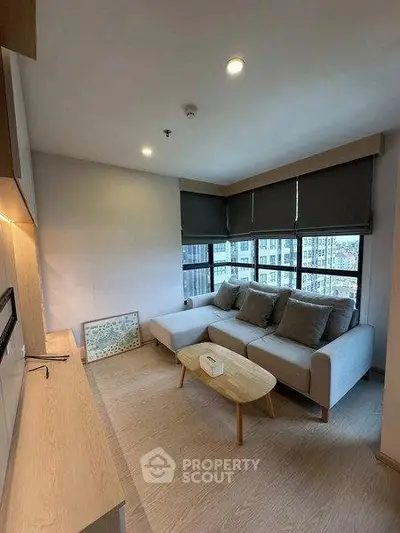 Modern living room with cozy sofa and city view, perfect for relaxation.