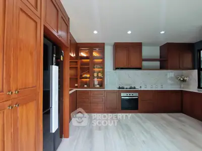 Spacious kitchen with elegant wooden cabinets and modern appliances