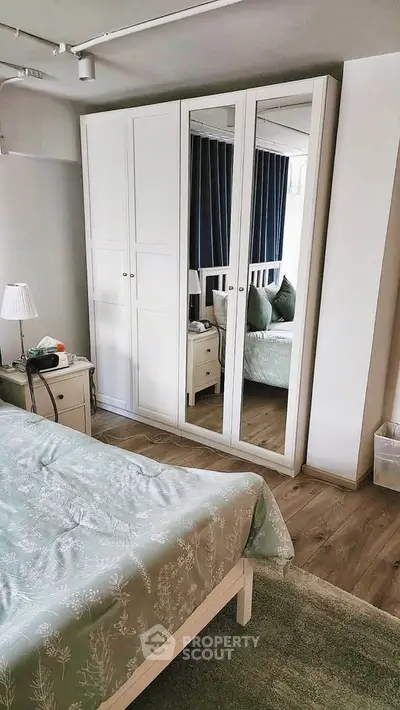 Cozy bedroom with mirrored wardrobe and elegant decor