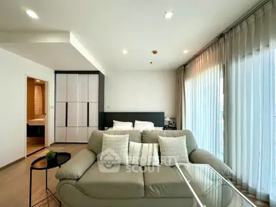 Modern living room with cozy sofa and large windows in a stylish apartment