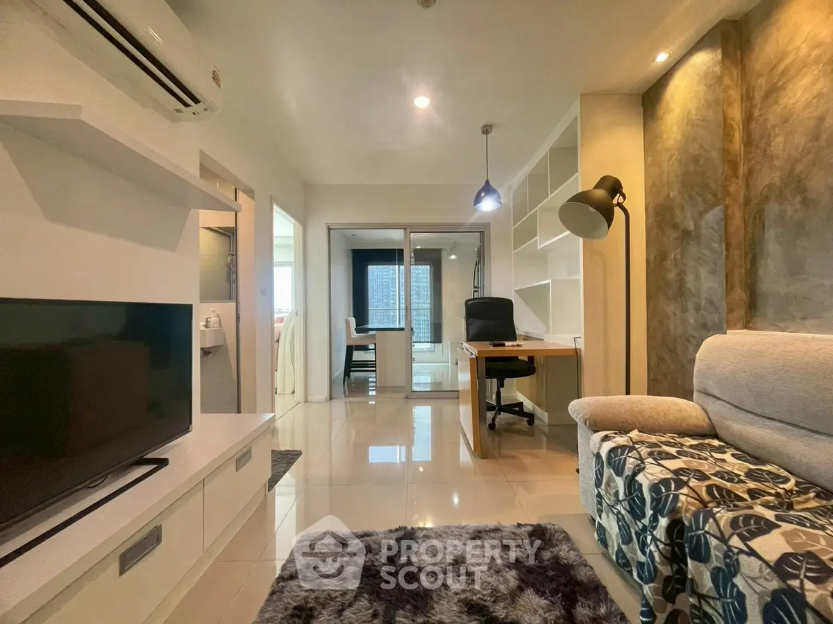 Modern living room with stylish decor and open study area, featuring sleek furniture and ambient lighting.