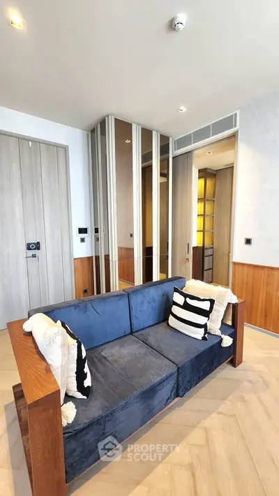 Modern living room with stylish blue sofa and wooden accents
