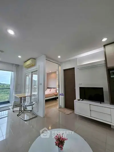 Modern open-plan living room with sleek furniture and natural light