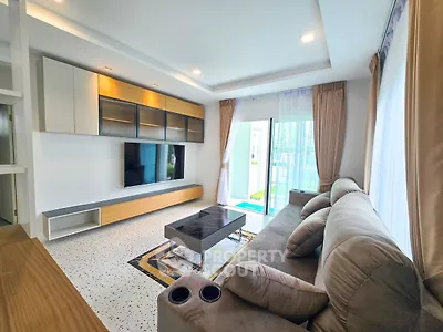 Modern living room with stylish furniture and large windows offering natural light.