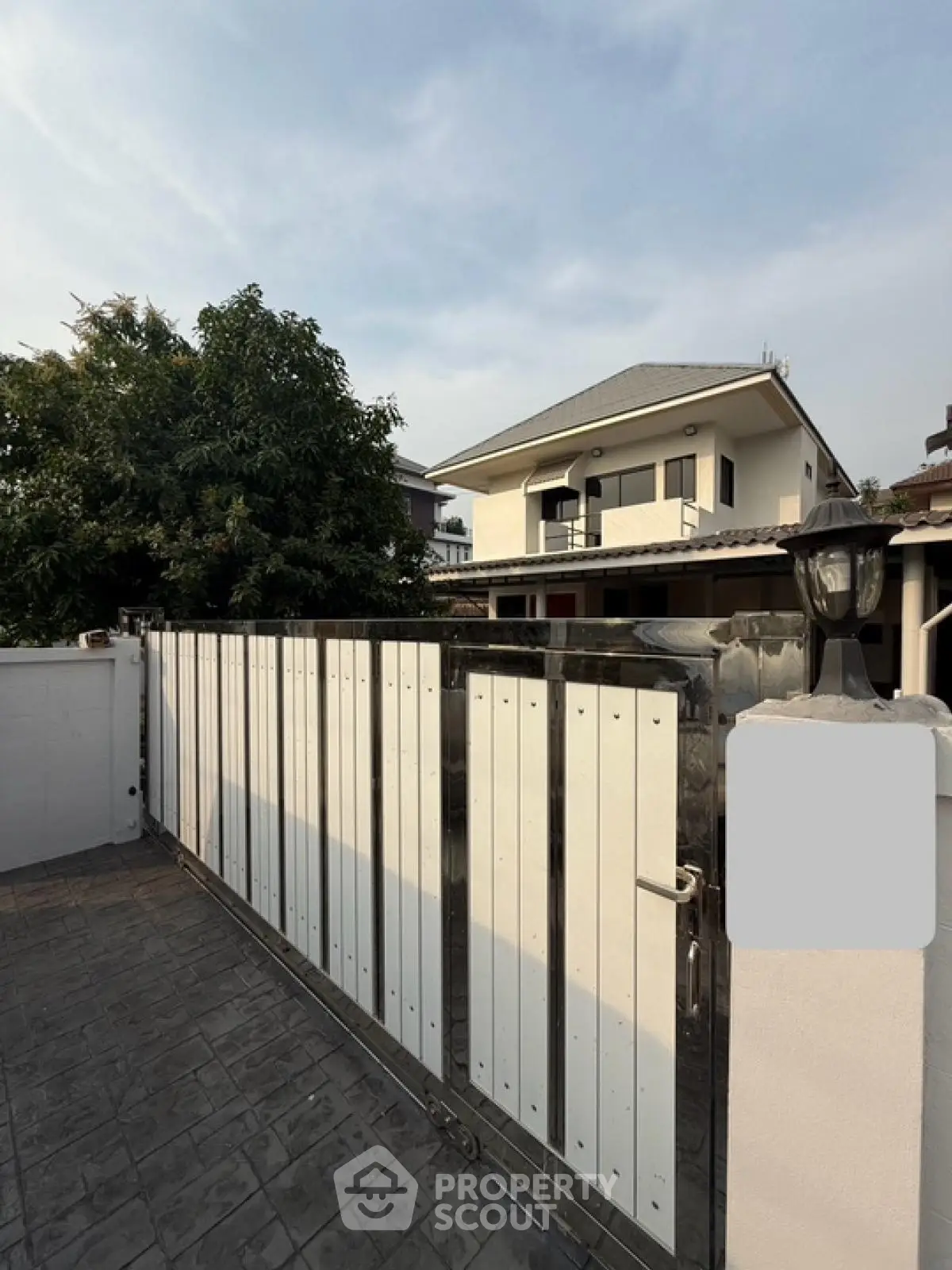 Charming two-story house with gated entrance and spacious driveway