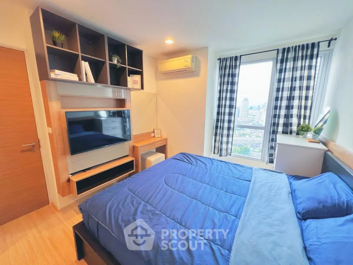 Modern bedroom with city view, stylish shelving, and cozy blue bedding.