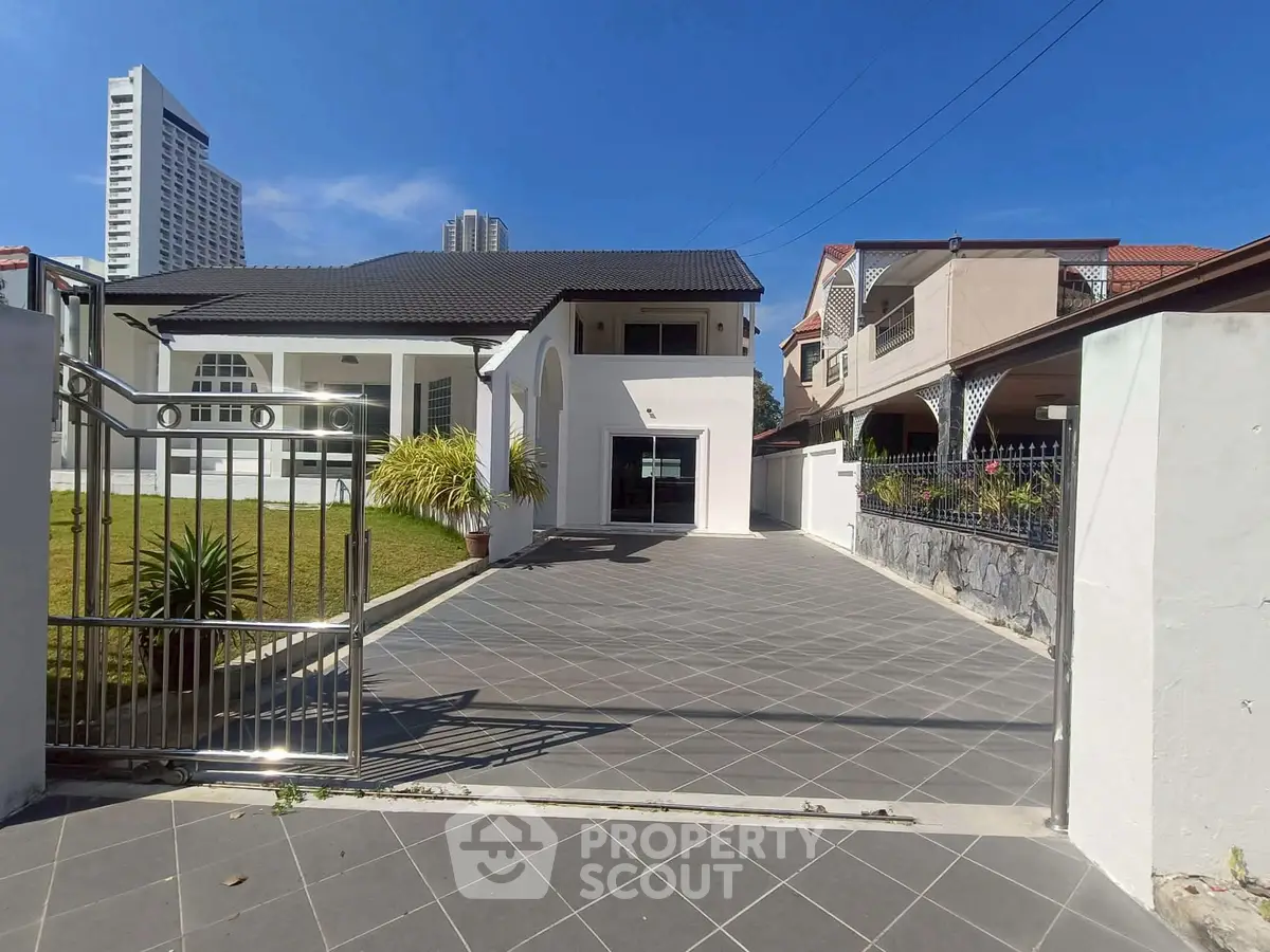 Spacious modern home with large driveway and lush garden in a prime neighborhood.