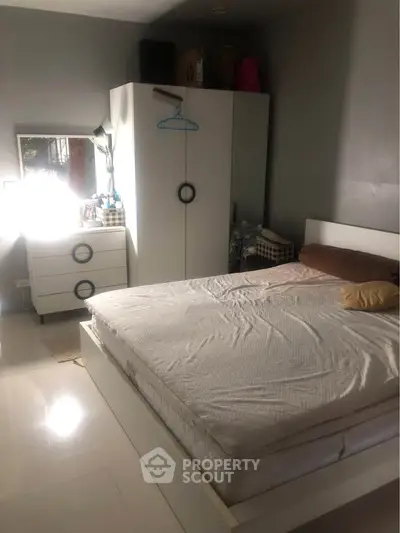 Cozy bedroom with modern white furniture and natural light