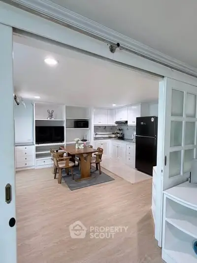 Spacious kitchen with dining area and modern appliances in a bright open layout.