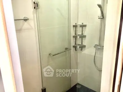 Modern bathroom with glass shower enclosure and sleek fixtures