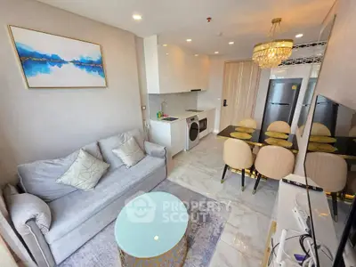 Modern living room with elegant decor, open kitchen, and dining area in a stylish apartment.
