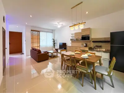 Spacious modern living room with open kitchen and elegant dining area