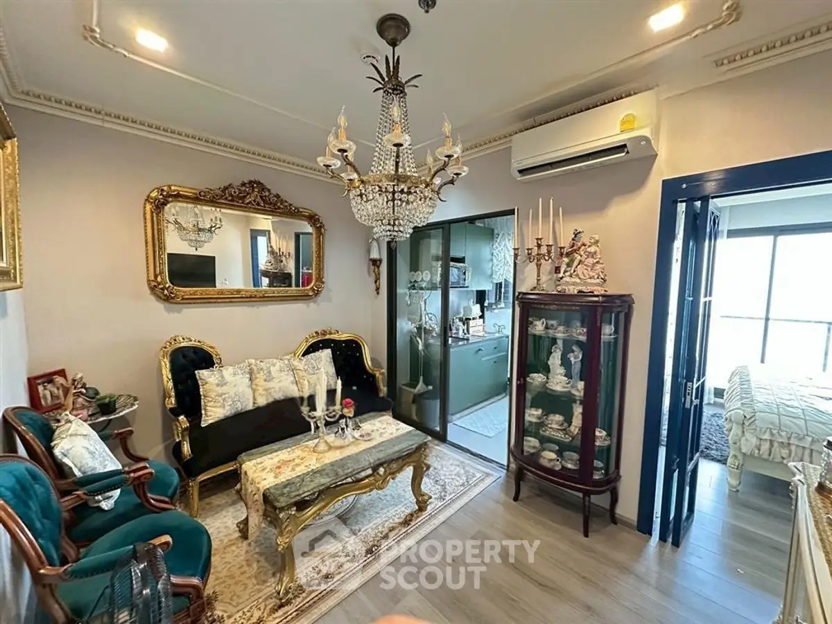Luxurious living room with elegant chandelier and classic furniture in a stylish apartment.