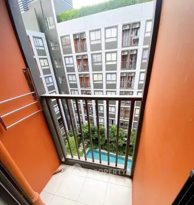 Modern apartment balcony with city view and pool below