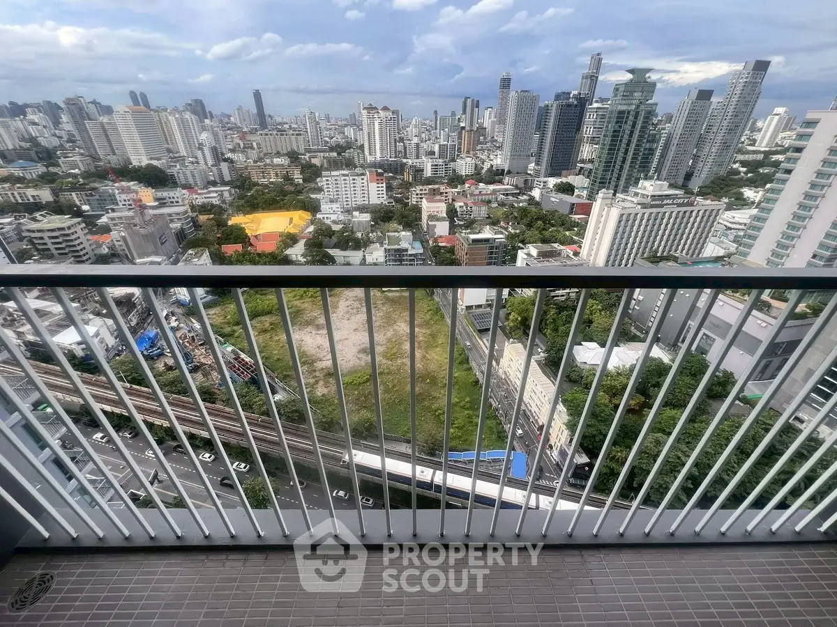 Stunning cityscape view from high-rise balcony overlooking urban skyline.