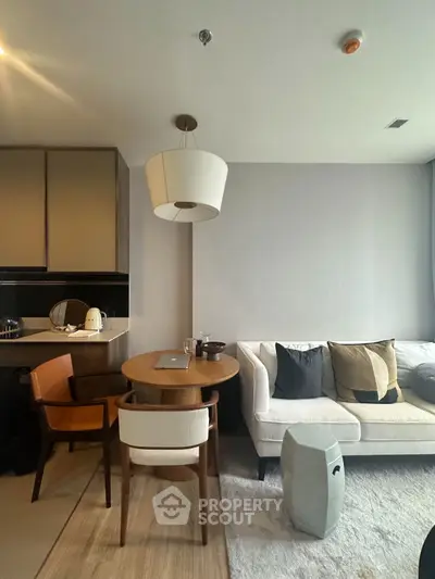 Modern living room with cozy seating and stylish dining area, perfect for urban living.