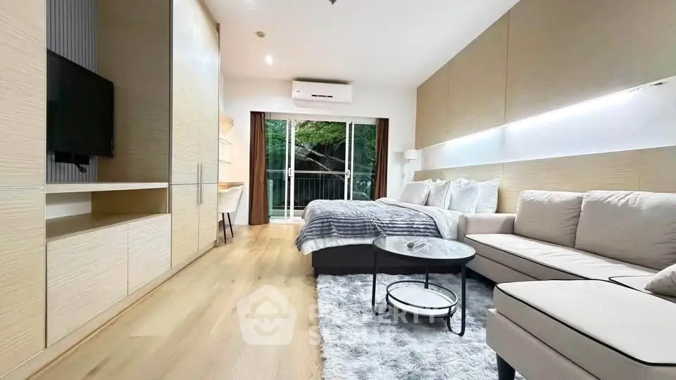 Modern living room with cozy sofa, stylish decor, and balcony view in a contemporary apartment.