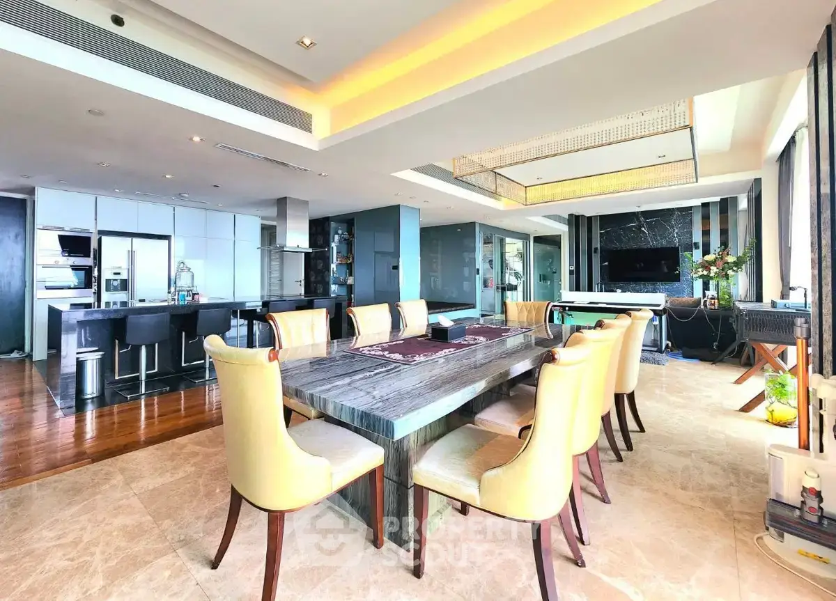 Luxurious open-plan living and dining area with modern kitchen and elegant decor