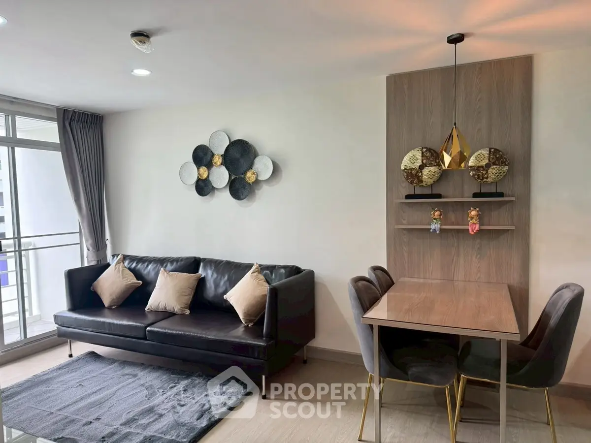 Modern living room with stylish decor and dining area in a chic apartment.
