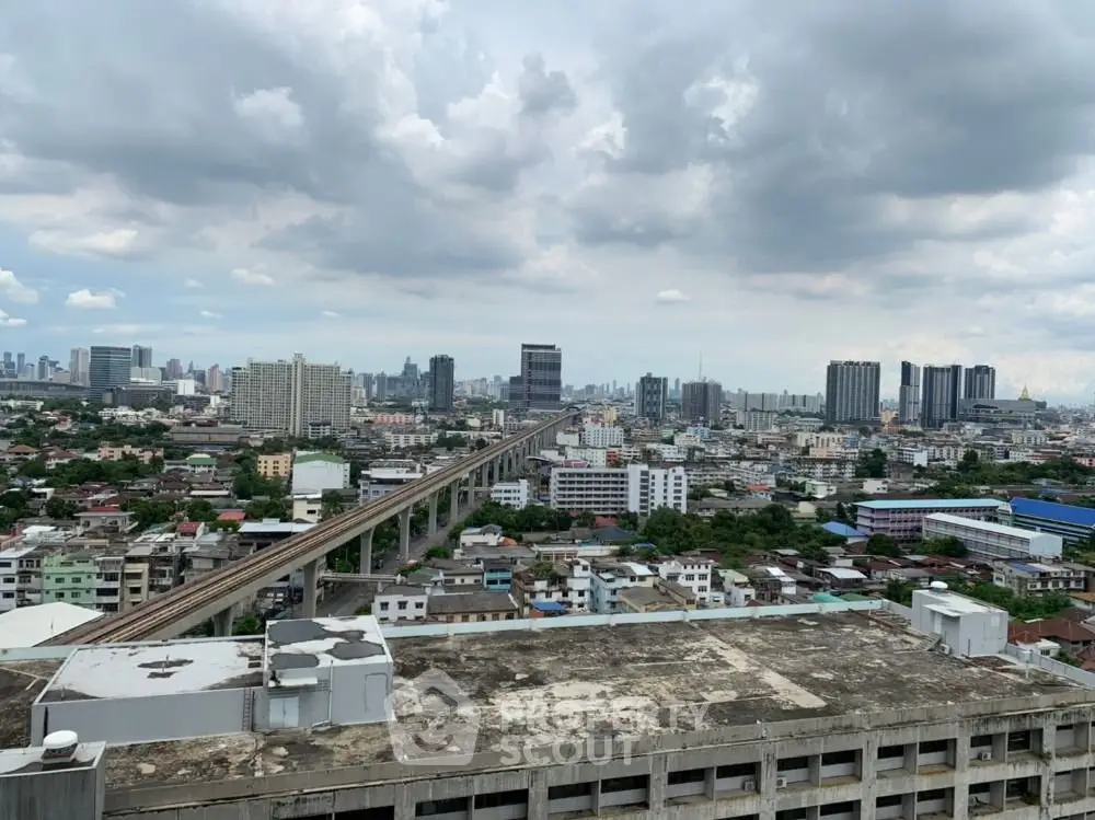 Stunning cityscape view from high-rise building showcasing urban skyline and expansive sky.