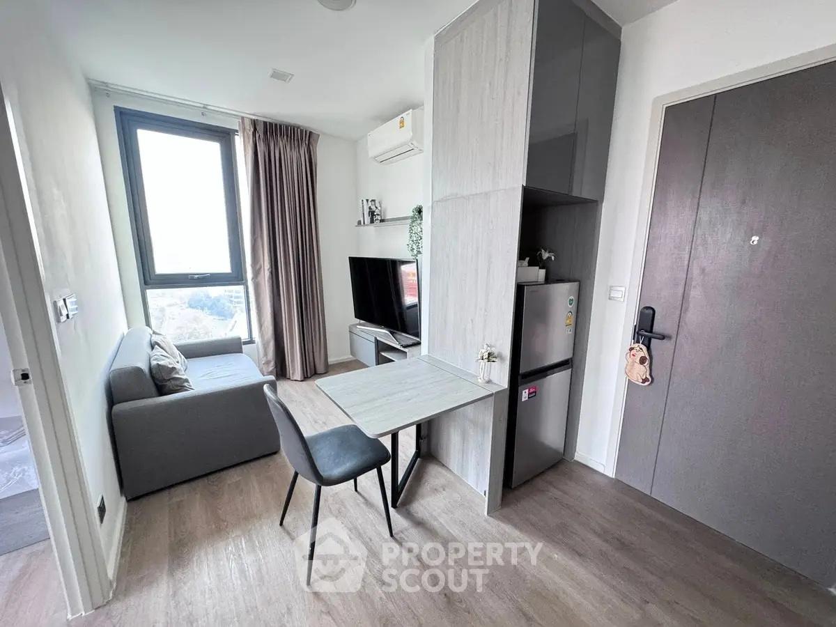 Modern living room with sleek furniture and natural light, perfect for urban living.