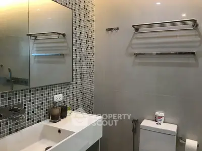 Modern bathroom with stylish mosaic tiles and sleek fixtures