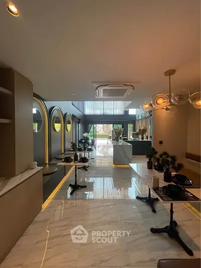 Luxurious open-plan living area with modern decor and elegant lighting