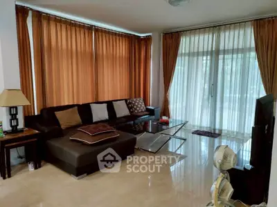 Spacious living room with modern furniture and large windows for natural light.