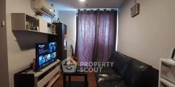 Cozy living room with modern decor and entertainment setup.