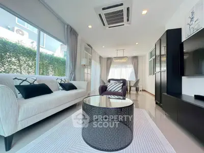 Spacious modern living room with elegant decor and ample natural light, perfect for relaxation and entertainment.
