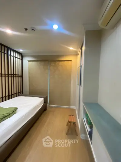 Cozy bedroom with modern design, featuring a comfortable bed and stylish decor.