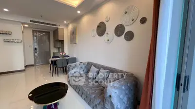 Modern living room with plush sofa and stylish wall decor in a contemporary apartment.