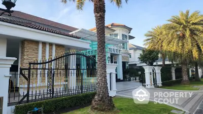 Luxurious mansion exterior with elegant driveway and palm trees