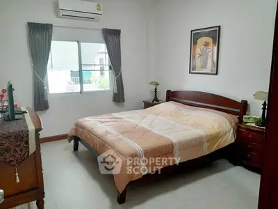 Cozy bedroom with elegant wooden furniture and natural light