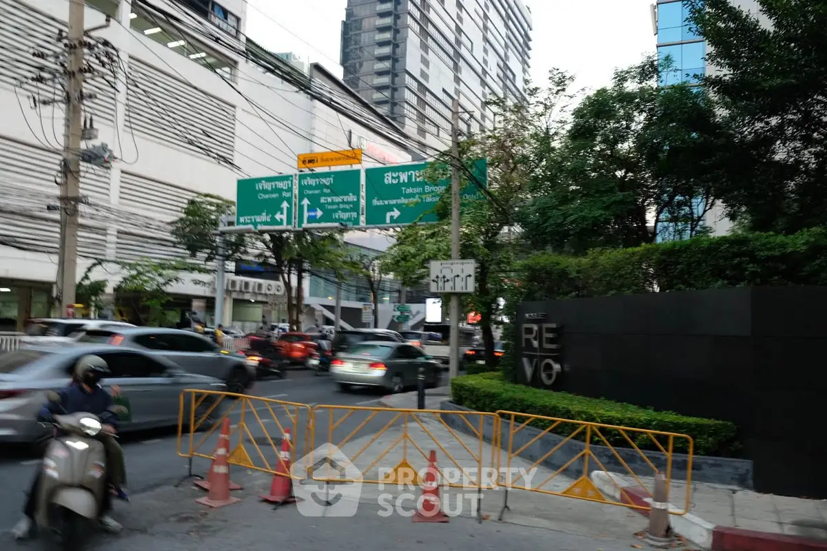 Urban street view with modern buildings and traffic in bustling city center.