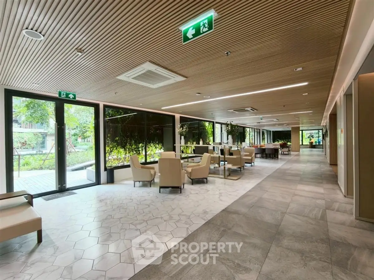 Modern building lobby with stylish seating and garden view