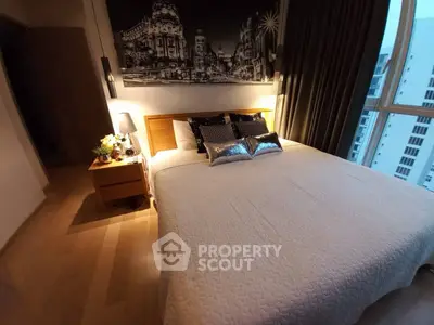 Cozy bedroom with cityscape artwork and large window view