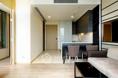 Modern open-plan living room with sleek kitchen and stylish furniture