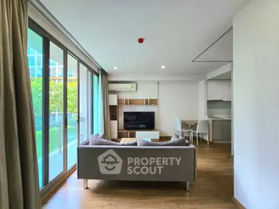Spacious modern living room with large windows and stylish furniture