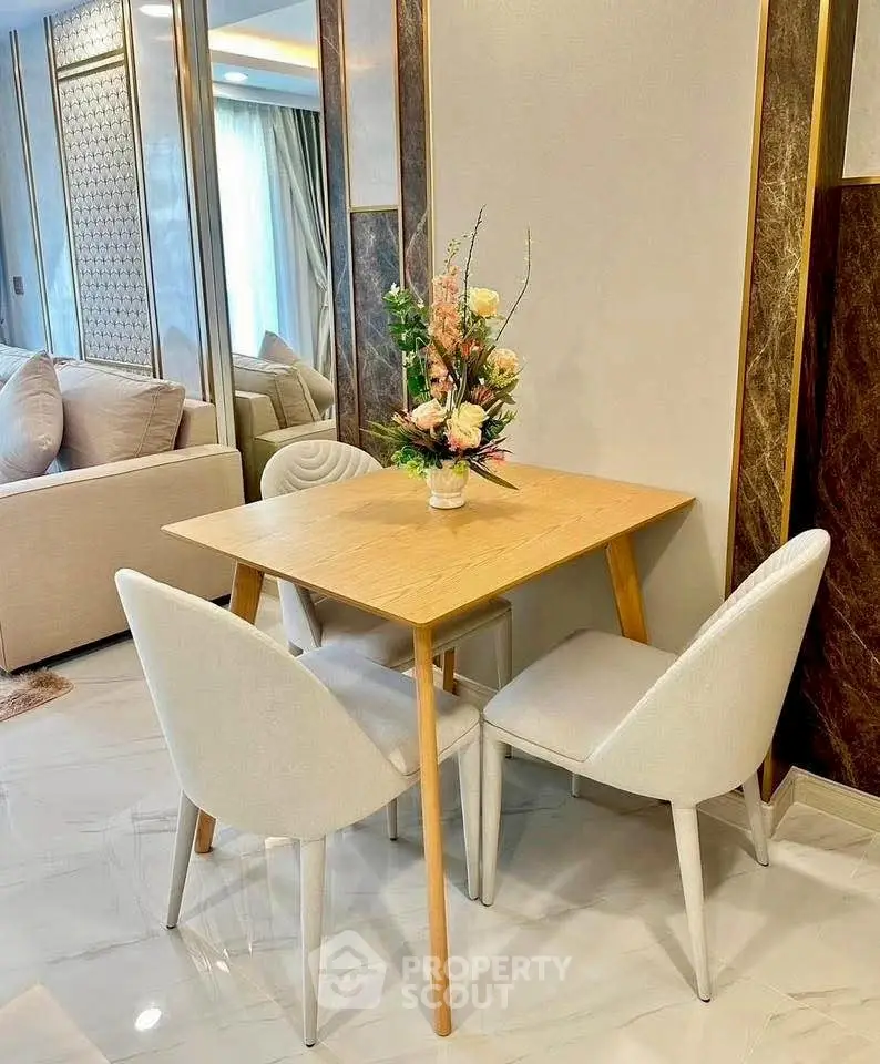 Elegant dining area with modern table and chairs, perfect for cozy meals in a stylish apartment.