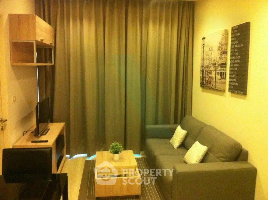 Cozy living room with modern furniture and stylish decor in a compact apartment.