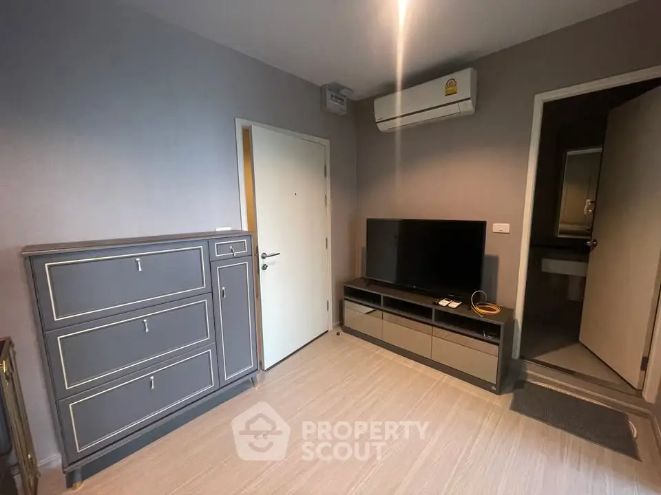 Modern living room with sleek furniture and air conditioning, ideal for comfortable living.