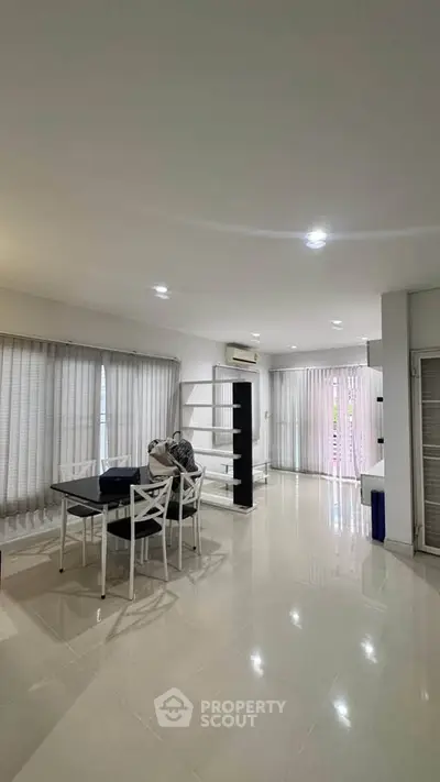 Spacious modern living room with dining area and large windows