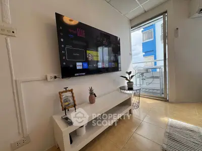 Modern living room with wall-mounted TV and balcony view