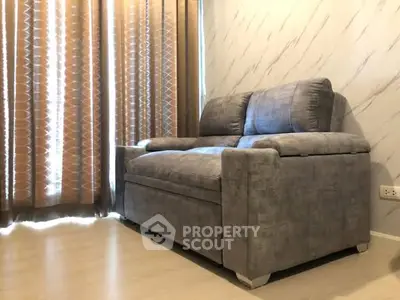 Cozy living room with stylish gray sofa and elegant curtains