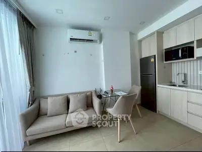 Modern living room with sleek kitchen and cozy seating area