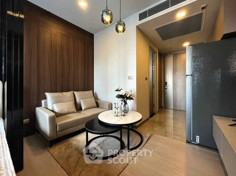 Modern living room with elegant decor and cozy seating in a stylish apartment.