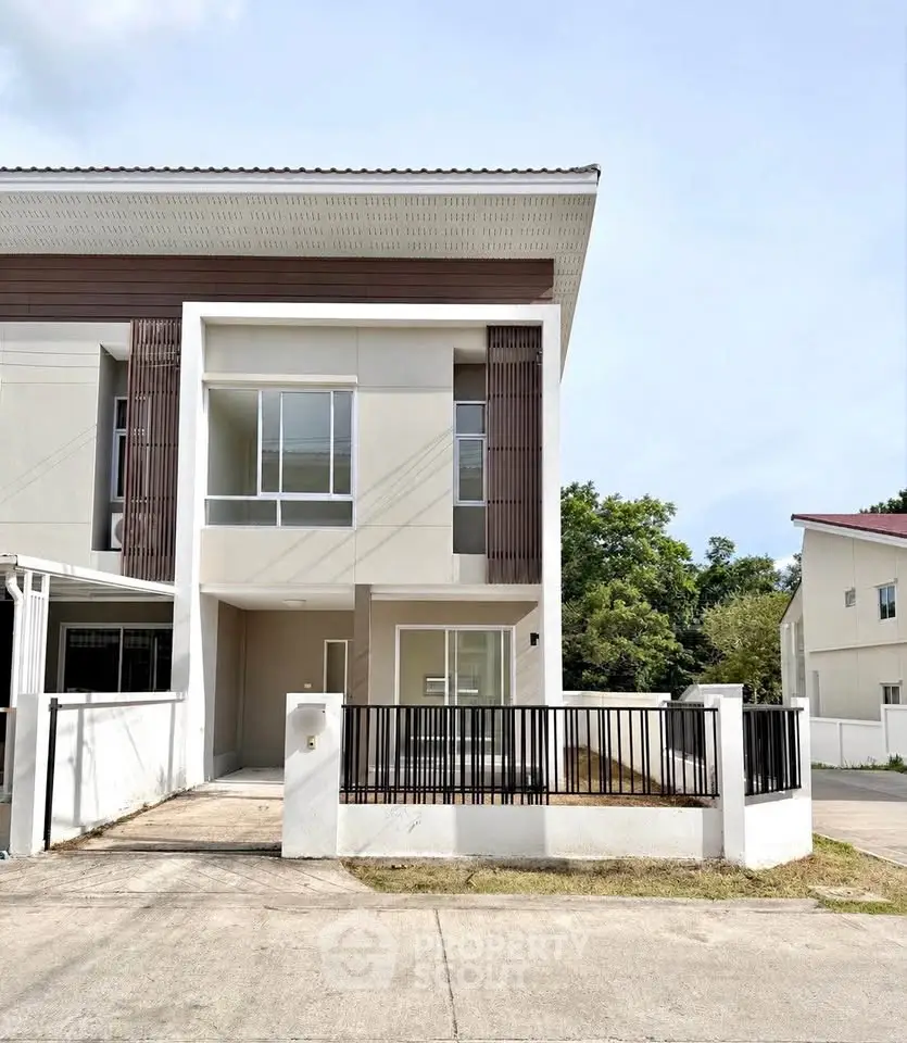 Modern two-story townhouse with sleek design and spacious front yard in a serene neighborhood.