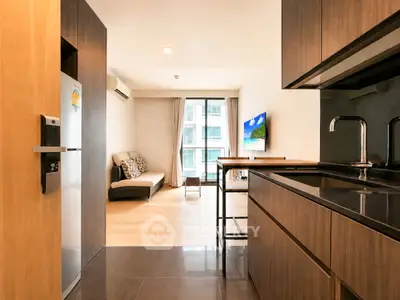 Modern open-plan kitchen and living room with sleek design and natural light